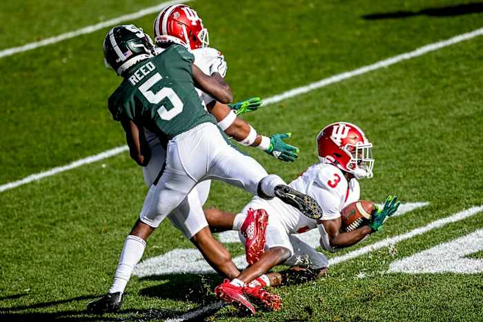 Michigan State's Indiana's Tiawan Mullen, right, intercepts a pass intended for Michigan State's Jayden Reed during the first quarter on Saturday, Nov. 14, 2020, at Spartan Stadium in East Lansing.